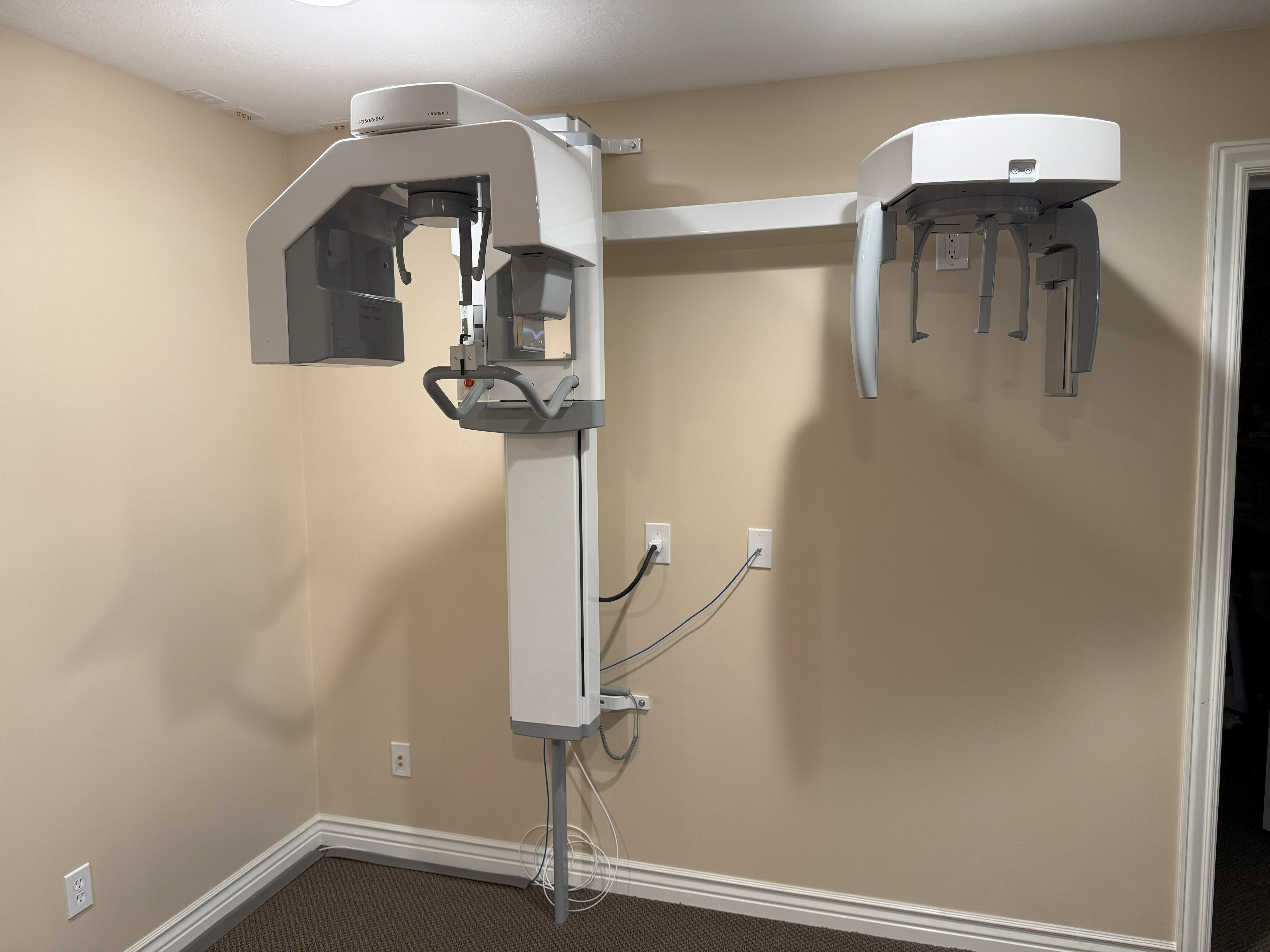 A room with two large white dental chairs.