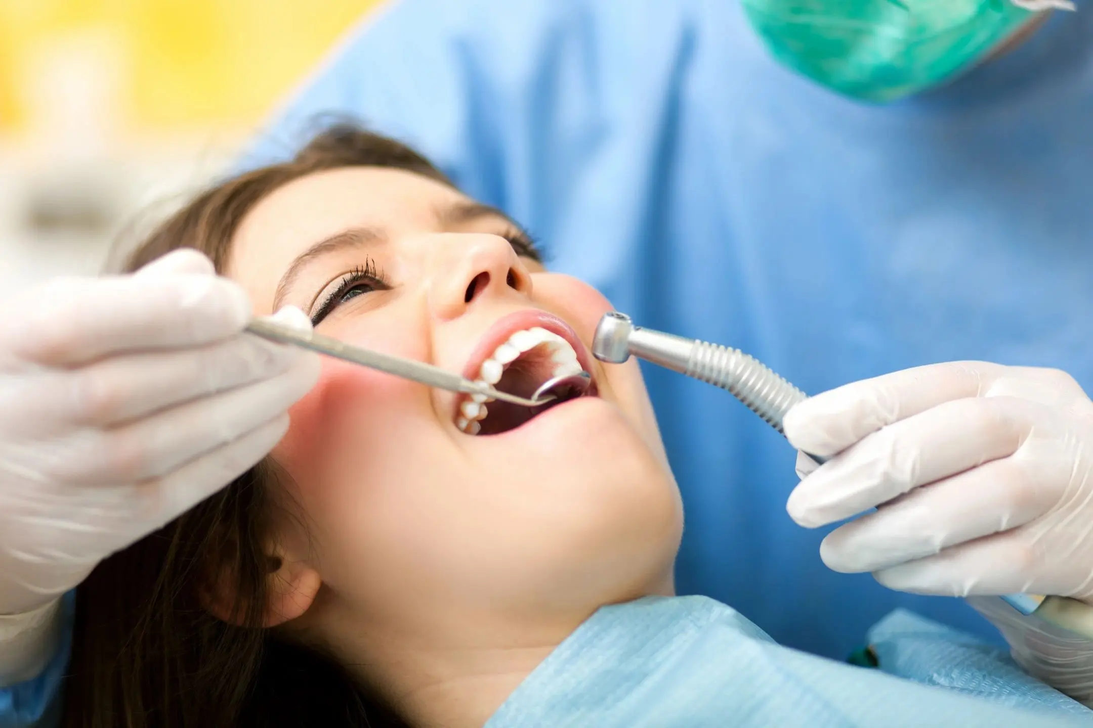 fm=f_2177 A woman is getting her teeth checked by an dentist.