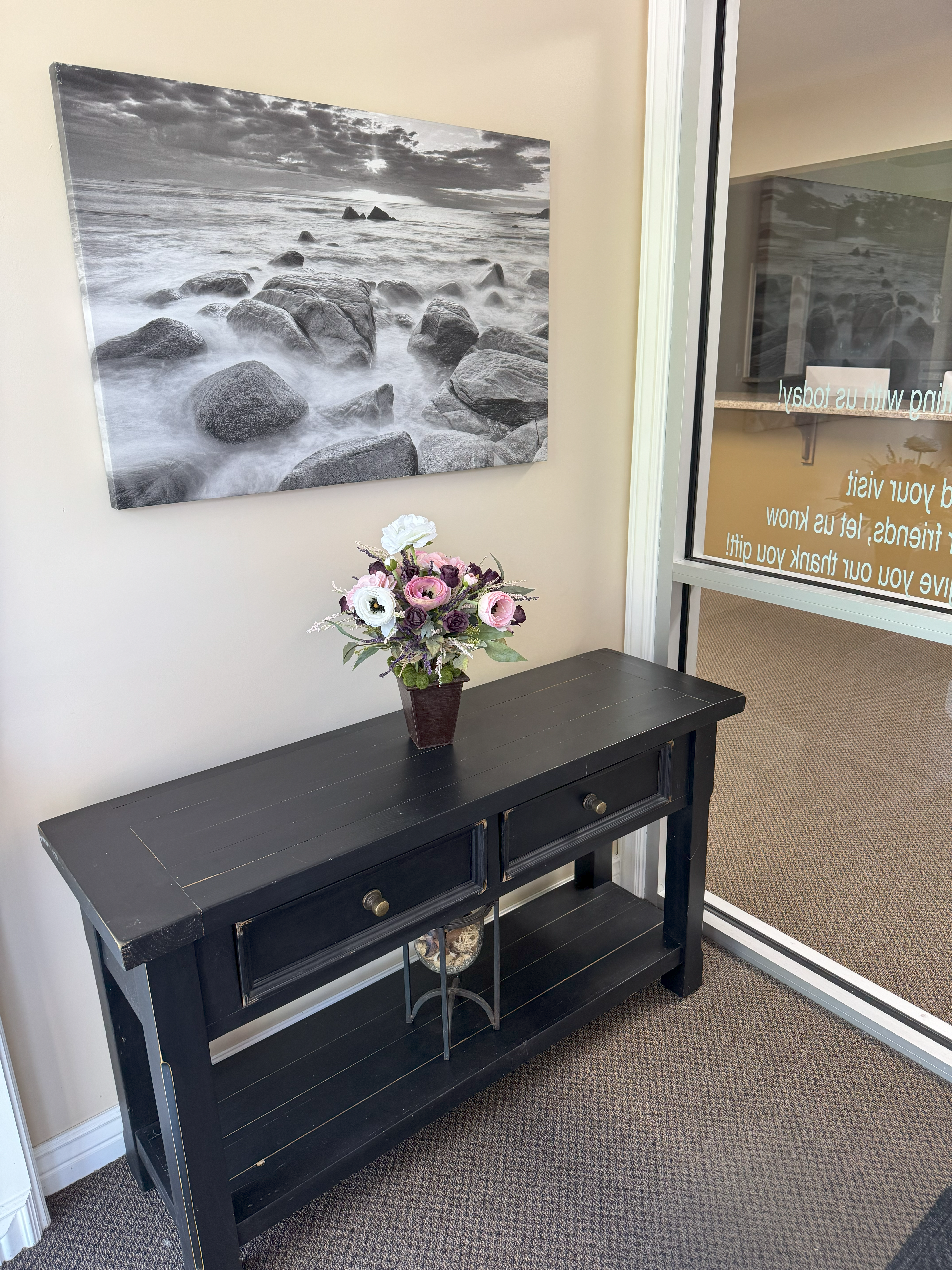 A black table with flowers in it